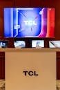 pexels-photo-25809252-25809252 Showroom display featuring TCL electronics including TVs and tablets with vibrant screens.